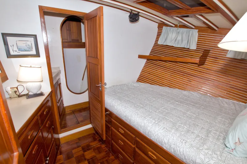 Slide: The Image of Cozy cabin interior of 1980 Kadey-Krogen 42 yacht with wooden furnishings and bed. - 72