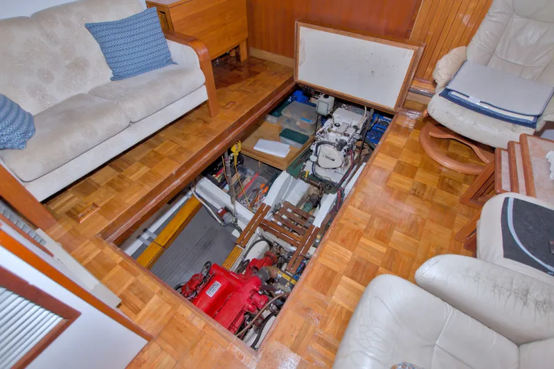 Slide: The Image of Engine room access in 1980 Kadey-Krogen 42 yacht, featuring parquet flooring and comfortable seating. - 83