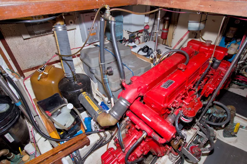 Slide: The Image of Engine room of a 1980 Kadey-Krogen 42 boat with red machinery and various equipment. - 85