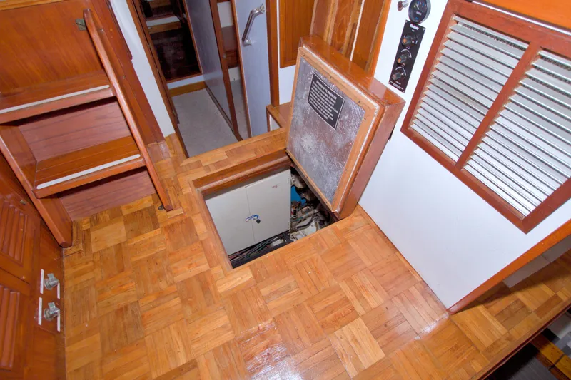 Slide: The Image of Interior of 1980 Kadey-Krogen 42 yacht with wooden flooring and open hatch. - 78