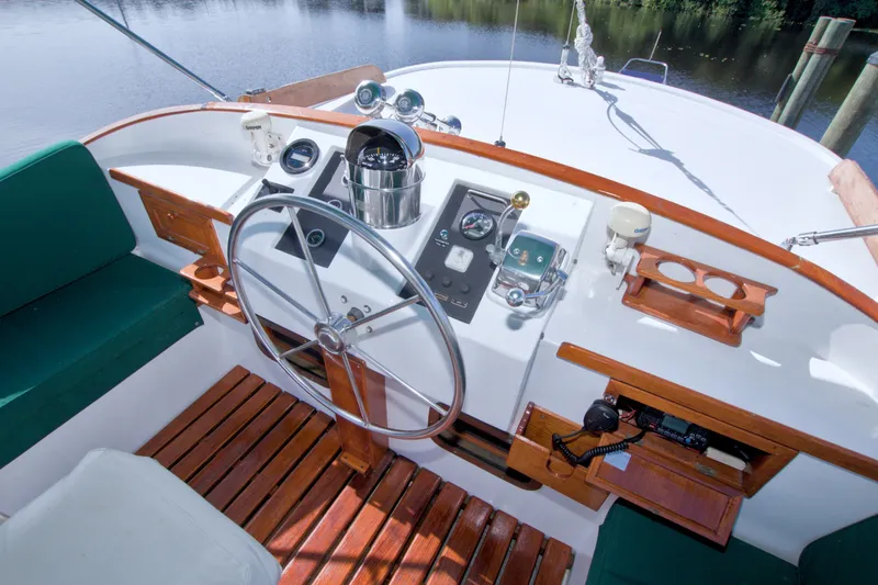 Slide: The Image of Cockpit of 1980 Kadey-Krogen 42 boat with steering wheel and navigation controls. - 16