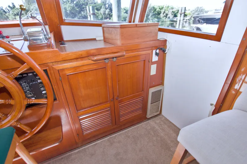 Slide: The Image of Interior of 1980 Kadey-Krogen 42 boat with wooden cabinetry and steering wheel. - 54
