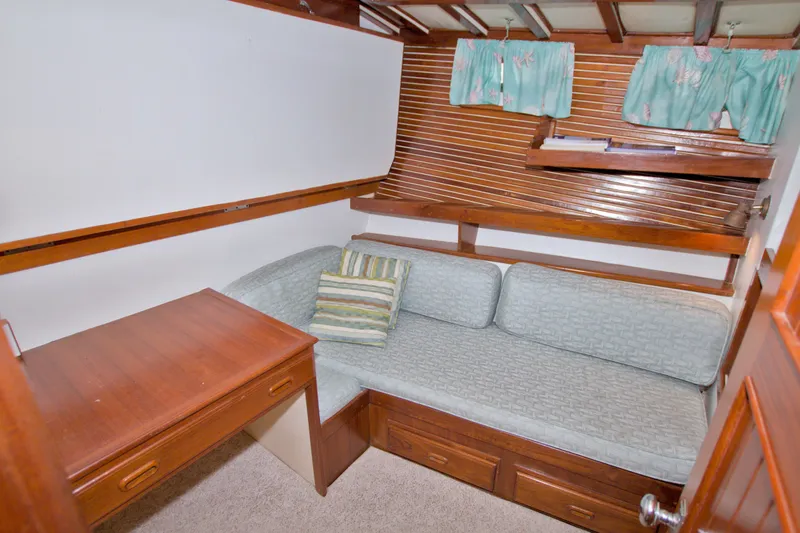 Slide: The Image of Cozy cabin interior of 1980 Kadey-Krogen 42 with wooden desk and cushioned seating. - 61
