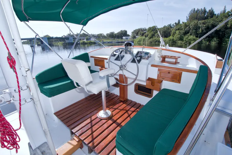 Slide: The Image of Cockpit of 1980 Kadey-Krogen 42 boat with green seating and wooden accents. - 14