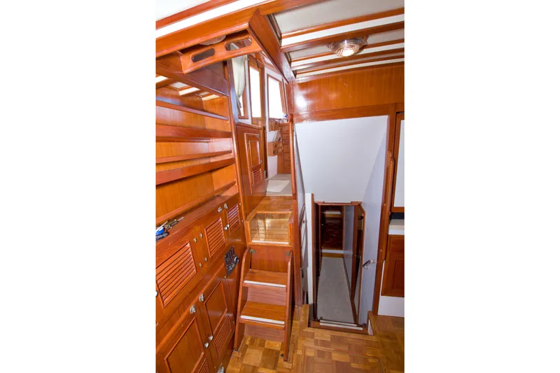Slide: The Image of Interior of 1980 Kadey-Krogen 42 yacht, featuring polished wood cabinetry and stairs. - 48