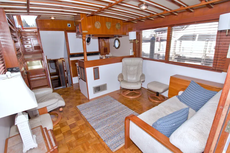 Slide: The Image of Interior of 1980 Kadey-Krogen 42 yacht with wooden decor, cozy seating, and large windows. - 41