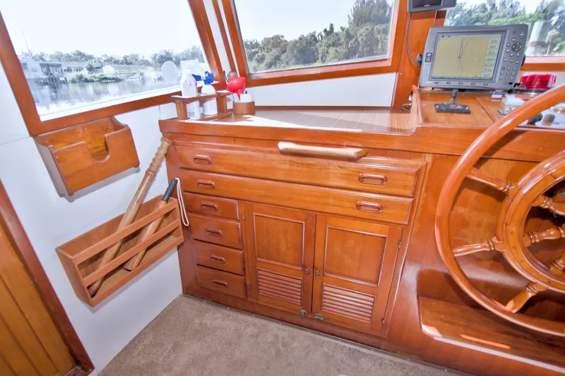 Slide: The Image of 1980 Kadey-Krogen 42 yacht helm with wooden cabinetry and navigation equipment. - 50