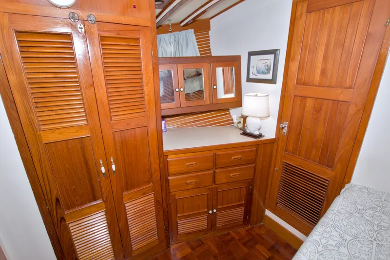 Slide: The Image of Cozy wooden interior of a 1980 Kadey-Krogen 42 yacht with cabinets and a lamp. - 71