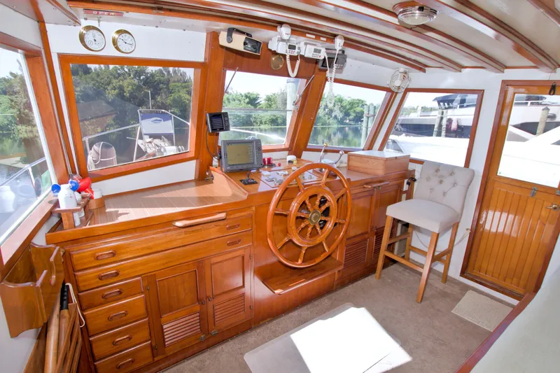 Slide: The Image of Interior of 1980 Kadey-Krogen 42 yacht with wooden helm and navigation equipment. - 49