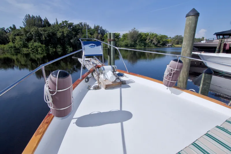 Slide: The Image of Bow view of 1980 Kadey-Krogen 42 yacht docked by serene waters. - 27