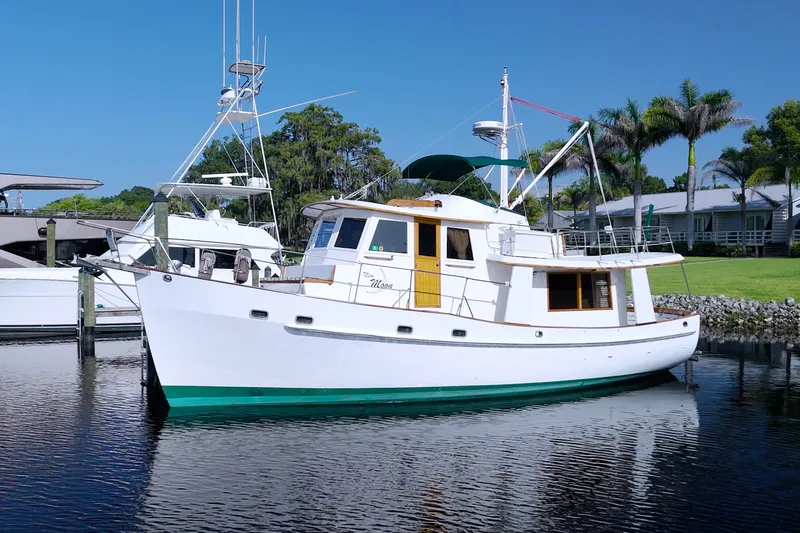 The Image of 1980 Kadey-Krogen 42 yacht docked in a serene marina setting. - 0