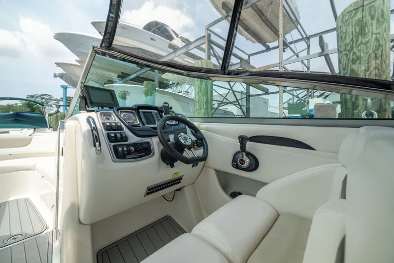 Slide: The Image of 2011 Chaparral 287 SSX boat cockpit with steering wheel and control panel. - 15