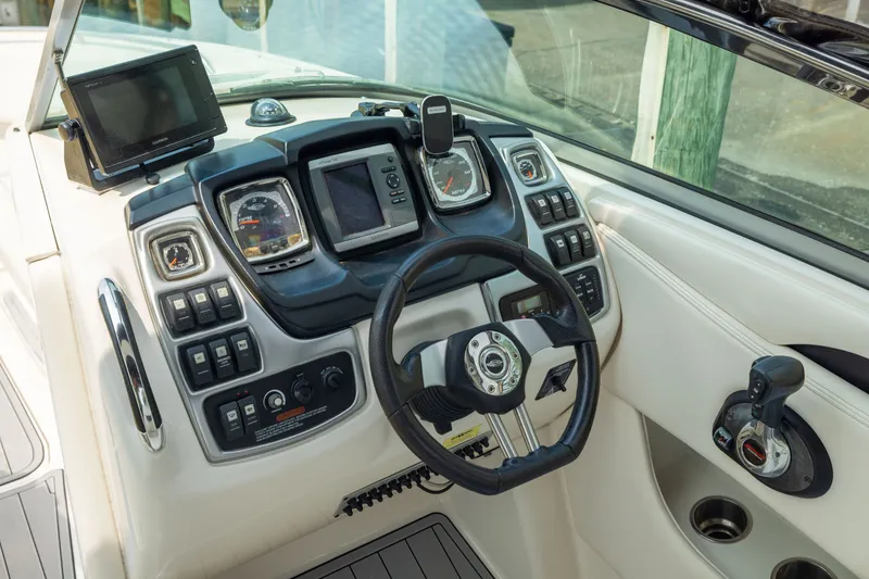 Slide: The Image of Cockpit of 2011 Chaparral 287 SSX boat with steering wheel and control panel. - 16