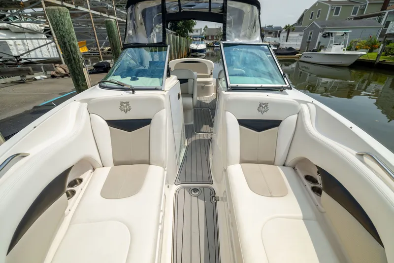 Slide: The Image of 2011 Chaparral 287 SSX boat interior with beige seating and sleek design. - 20