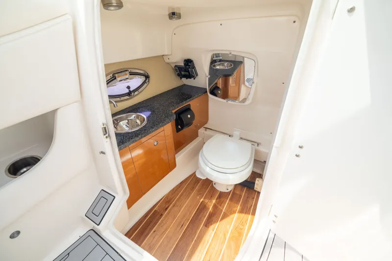 Slide: The Image of 2011 Chaparral 287 SSX boat bathroom with sink, toilet, and wooden flooring. - 18