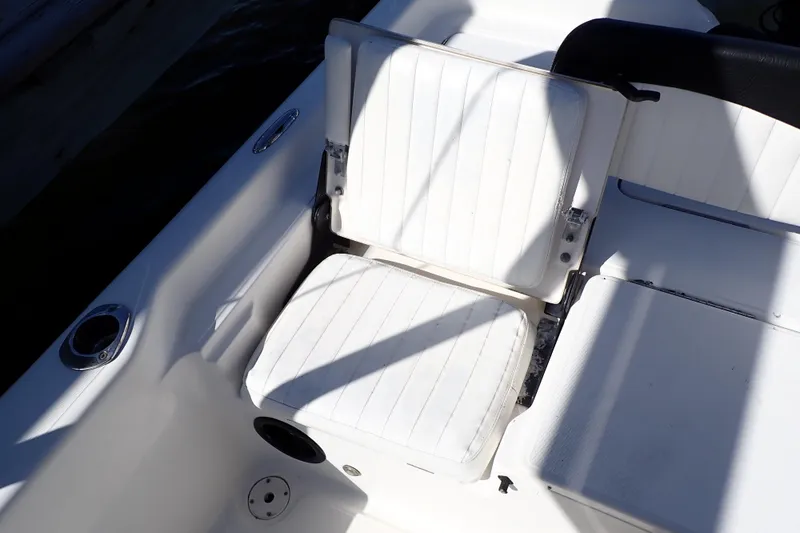 Slide: The Image of White seating on a 2015 Blue Wave 2400 PureBay boat, featuring clean lines and cup holders. - 64