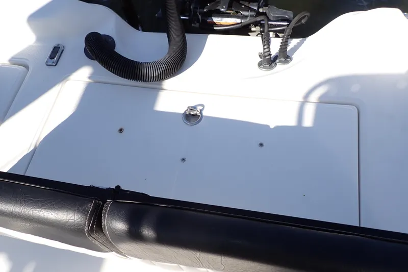 Slide: The Image of 2015 Blue Wave 2400 PureBay boat deck with storage compartment and black trim. - 73