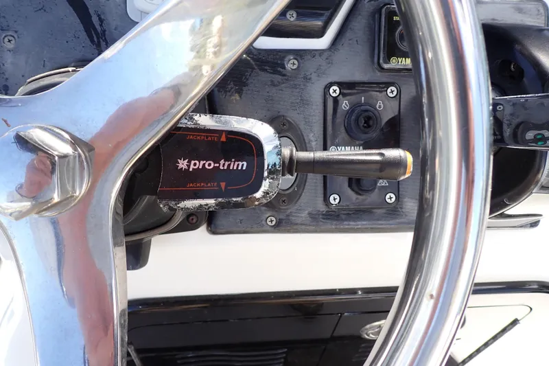 Slide: The Image of Steering wheel and controls of a 2015 Blue Wave 2400 PureBay boat. - 31