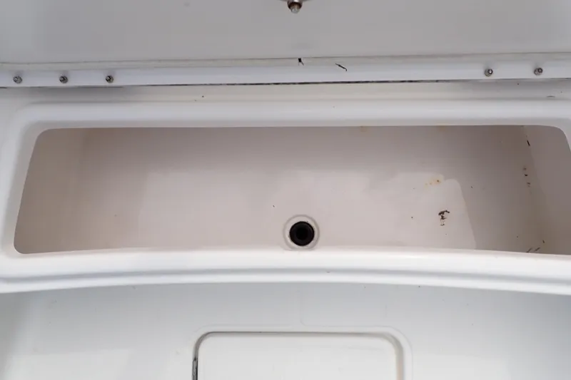 Slide: The Image of Open storage compartment on a 2015 Blue Wave 2400 PureBay boat. - 44