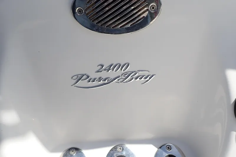 Slide: The Image of 2015 Blue Wave 2400 PureBay boat emblem on white surface. - 105