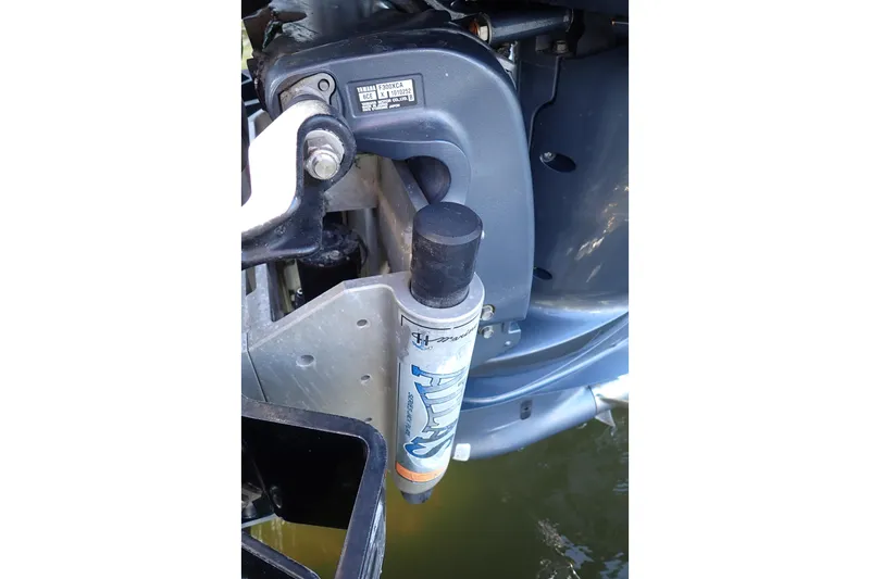Slide: The Image of Close-up of a 2015 Blue Wave 2400 PureBay boat engine component in water. - 92