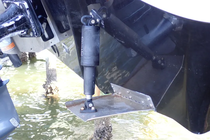 Slide: The Image of Trim tab on a 2015 Blue Wave 2400 PureBay boat in water. - 101