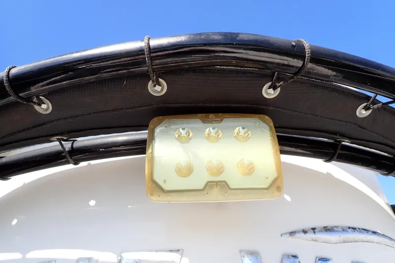Slide: The Image of LED light on 2015 Blue Wave 2400 PureBay boat against clear blue sky. - 53