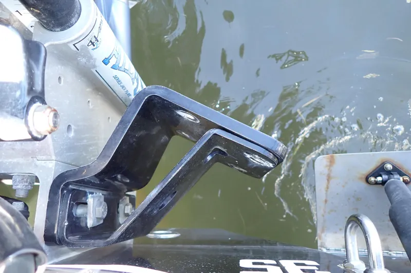 Slide: The Image of Close-up of a 2015 Blue Wave 2400 PureBay boat component near water. - 93