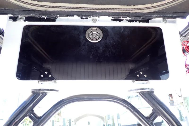 Slide: The Image of 2015 Blue Wave 2400 PureBay boat storage compartment with black lid and latch. - 55