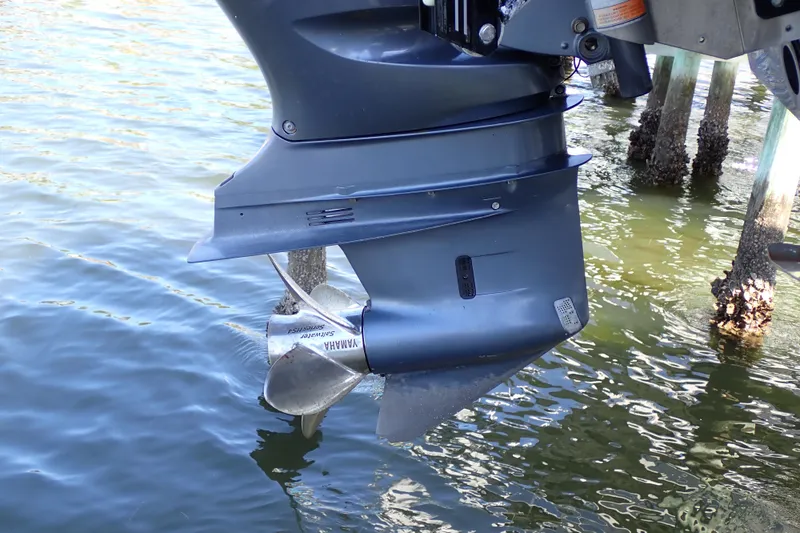 Slide: The Image of Outboard motor of a 2015 Blue Wave 2400 PureBay boat in water. - 100