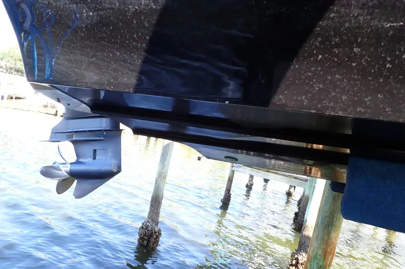 Slide: The Image of 2015 Blue Wave 2400 PureBay boat hull and motor above water. - 97