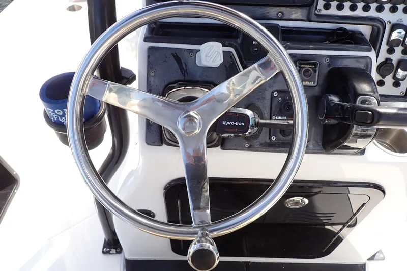 Slide: The Image of Steering wheel and controls of a 2015 Blue Wave 2400 PureBay boat. - 30
