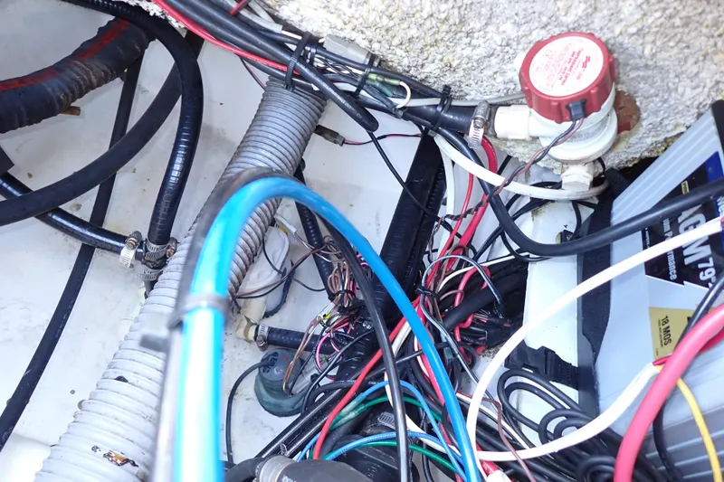 Slide: The Image of Tangled wiring and components inside a 2015 Blue Wave 2400 PureBay boat. - 85