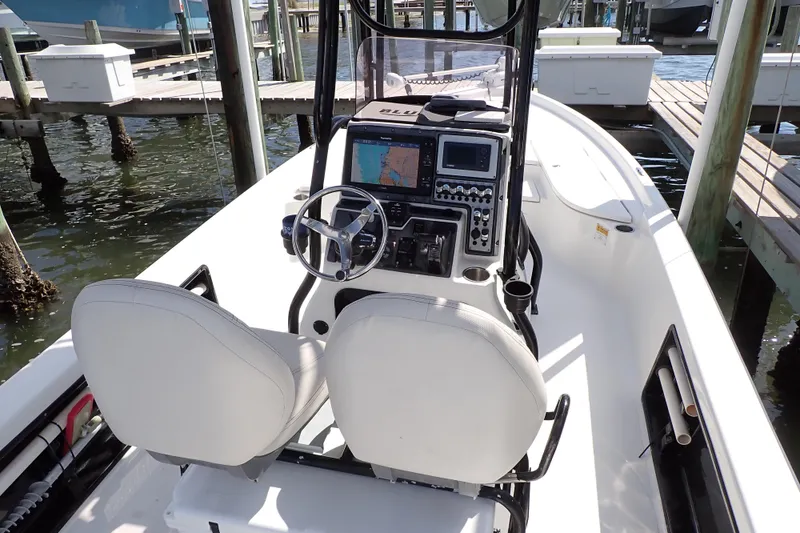 Slide: The Image of 2015 Blue Wave 2400 PureBay boat interior with dual seats and navigation controls. - 14
