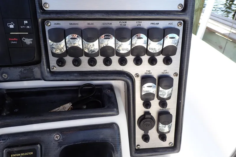 Slide: The Image of Control panel of a 2015 Blue Wave 2400 PureBay boat with labeled switches. - 26