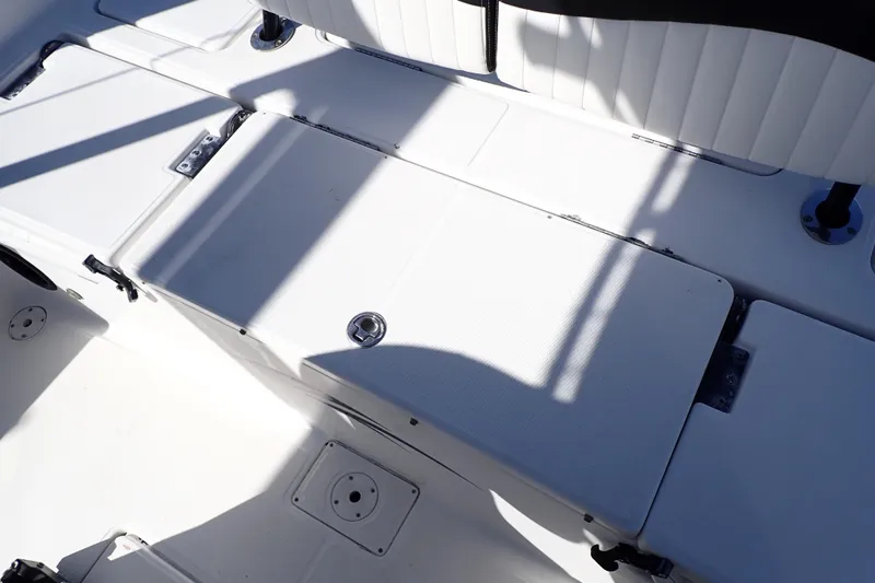 Slide: The Image of 2015 Blue Wave 2400 PureBay boat interior with white seating and storage compartments. - 66