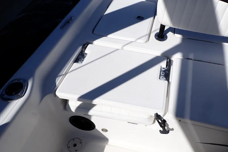 Slide: The Image of Interior view of a 2015 Blue Wave 2400 PureBay boat, featuring seating and storage compartments. - 63