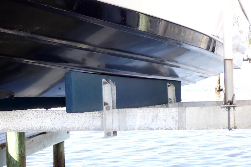 Slide: The Image of Blue Wave 2400 PureBay 2015 boat hull on lift above water. - 103