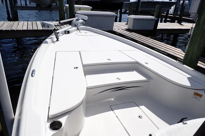 Slide: The Image of 2015 Blue Wave 2400 PureBay boat docked, showcasing spacious deck and sleek design. - 17