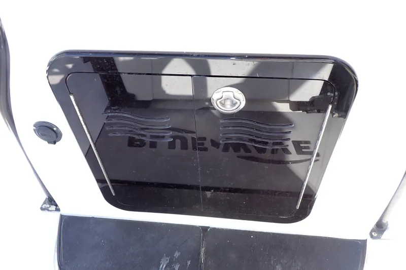Slide: The Image of 2015 Blue Wave 2400 PureBay boat compartment with logo and latch. - 57