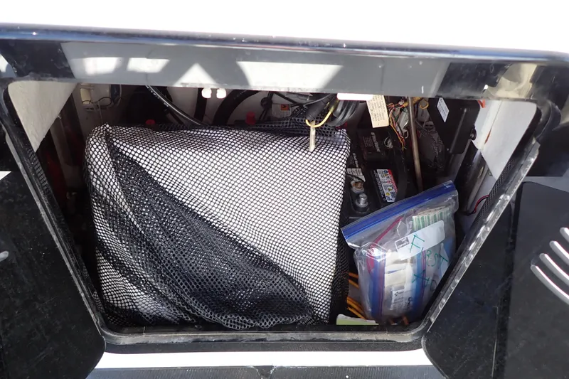Slide: The Image of Storage compartment of a 2015 Blue Wave 2400 PureBay boat with organized gear. - 58