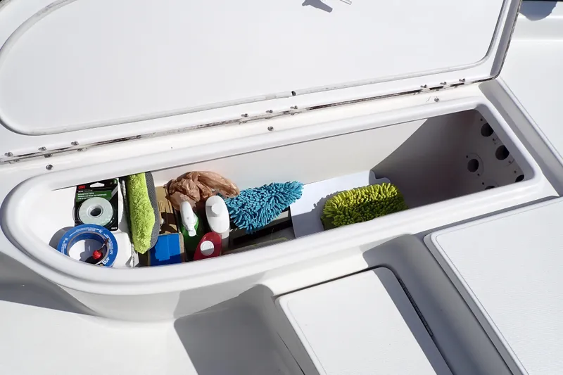 Slide: The Image of Storage compartment on a 2015 Blue Wave 2400 PureBay boat with cleaning supplies. - 46