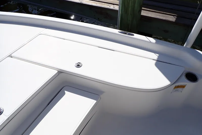 Slide: The Image of 2015 Blue Wave 2400 PureBay boat deck with storage compartment and cup holder. - 48