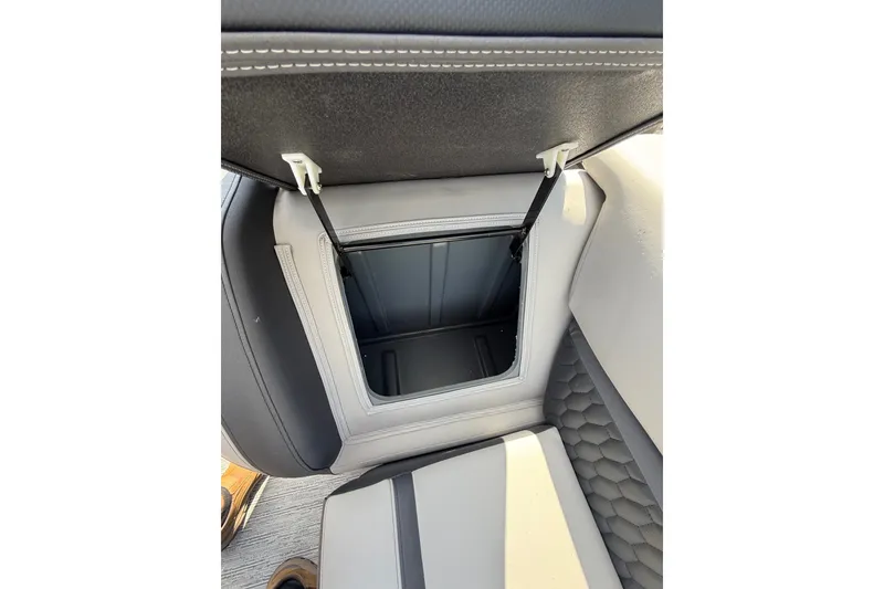 Slide: The Image of 2026 Sylvan L-3 LZ DH boat seat storage compartment, open with visible interior. - 24