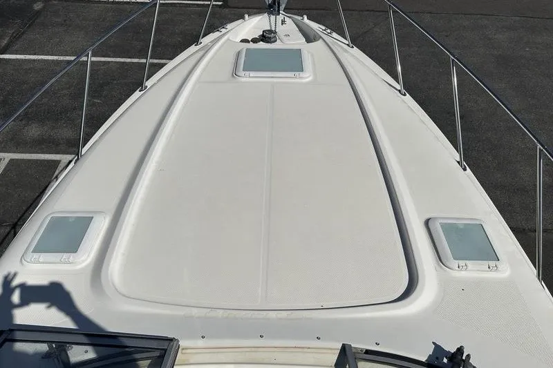 Slide: The Image of 2004 Bayliner 3055 Ciera Sunbridge boat deck with hatches and railing. - 36
