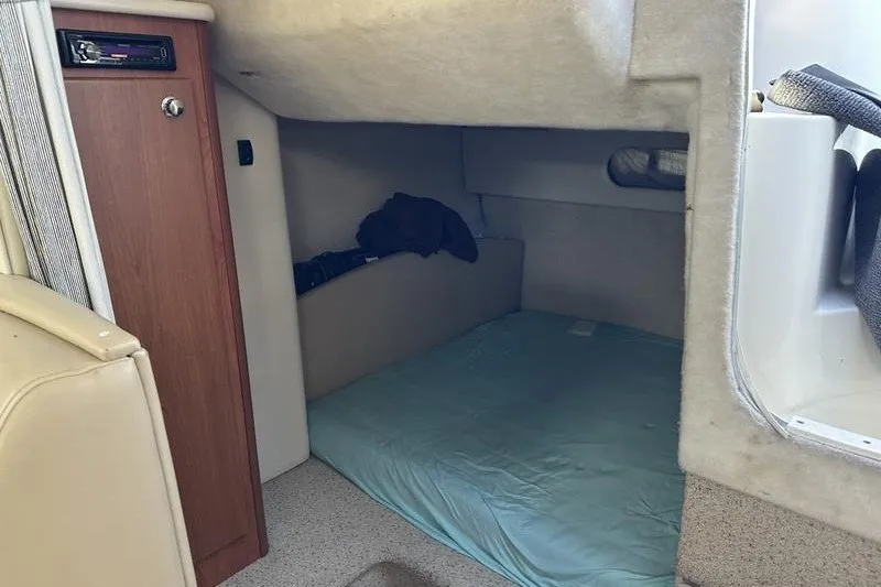 Slide: The Image of 2004 Bayliner 3055 Ciera Sunbridge cabin interior with bed and storage. - 38