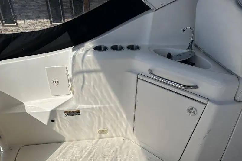 Slide: The Image of 2004 Bayliner 3055 Ciera Sunbridge interior with sink and storage compartments. - 19