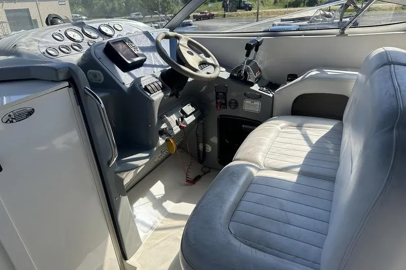 Slide: The Image of 2004 Bayliner 3055 Ciera Sunbridge cockpit with steering wheel and control panel. - 18