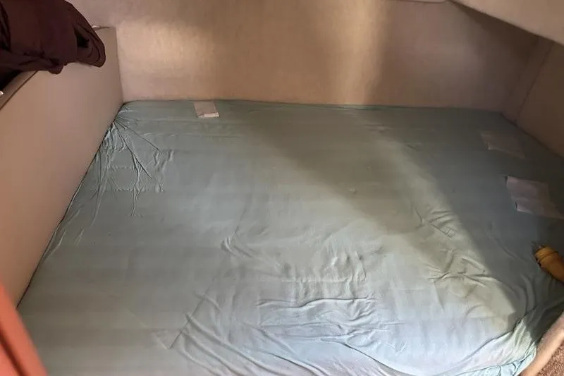 Slide: The Image of Interior cabin bed of 2004 Bayliner 3055 Ciera Sunbridge with light blue sheets. - 39
