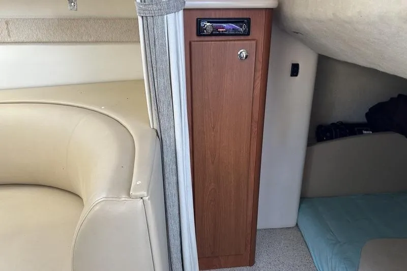 Slide: The Image of Interior of 2004 Bayliner 3055 Ciera Sunbridge, featuring seating and storage cabinet. - 40